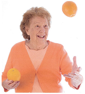 Elderly women playing with two oranges